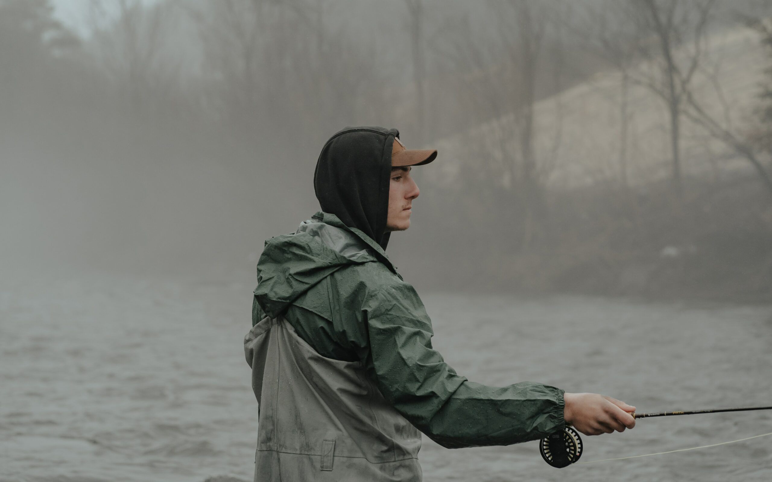 Man fly fishing in the rain