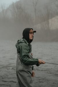 fishing in a river with PVC waders